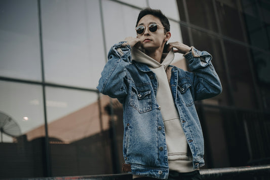 woman in blue denim jacket wearing black sunglasses