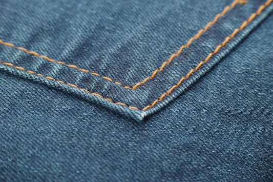 blue denim textile with white button
