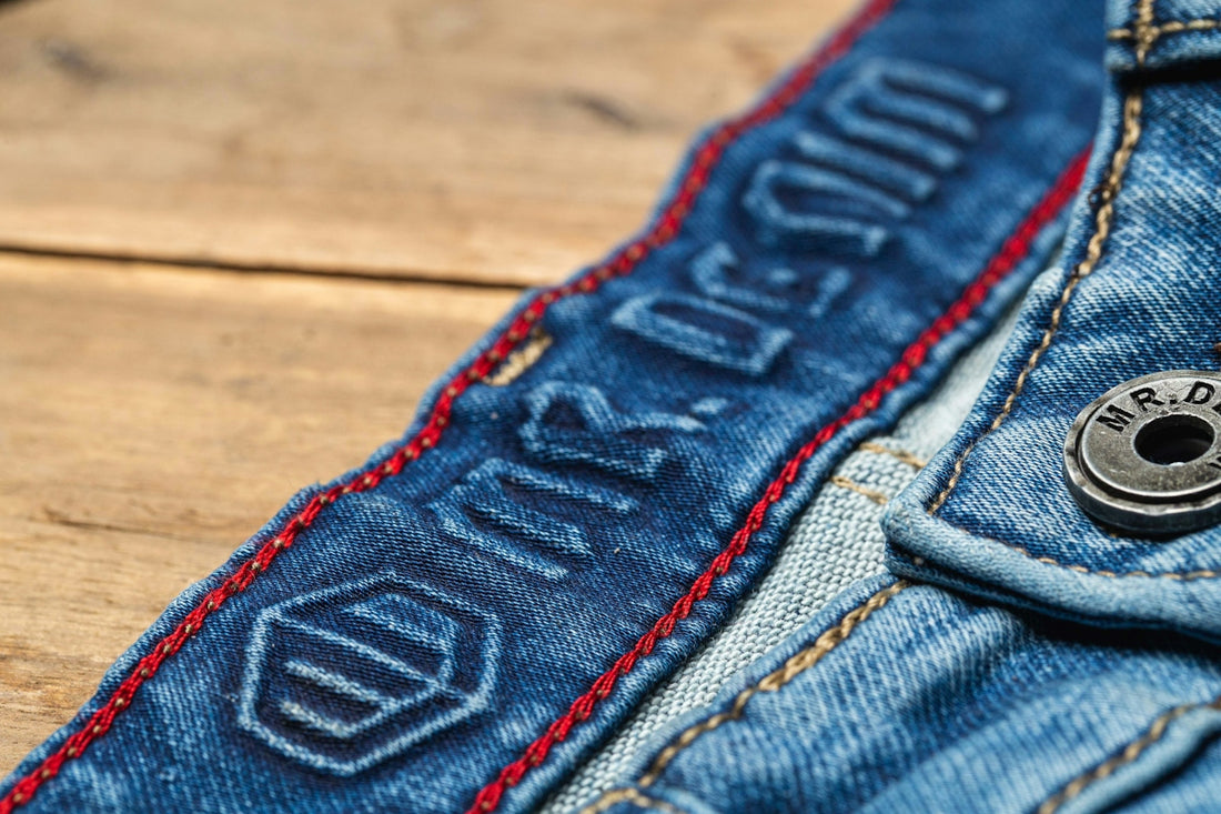 blue denim jeans on brown wooden table