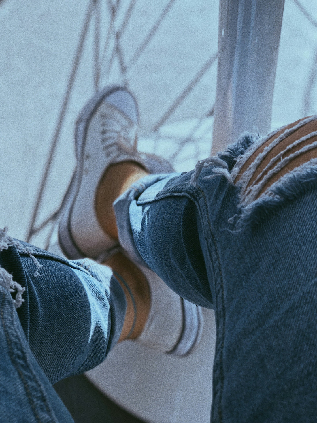 a person sitting on top of a metal pole