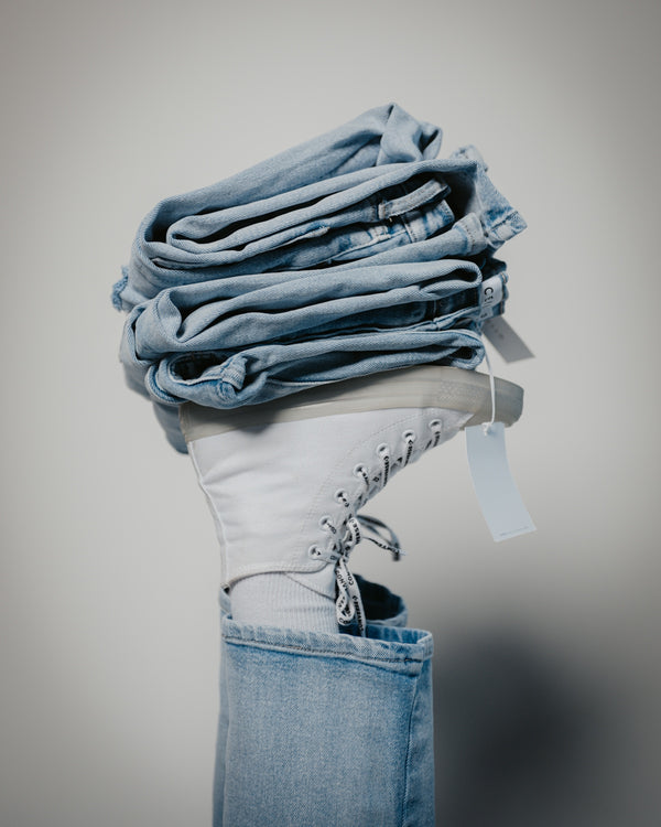 a stack of folded jeans in a jeans pocket
