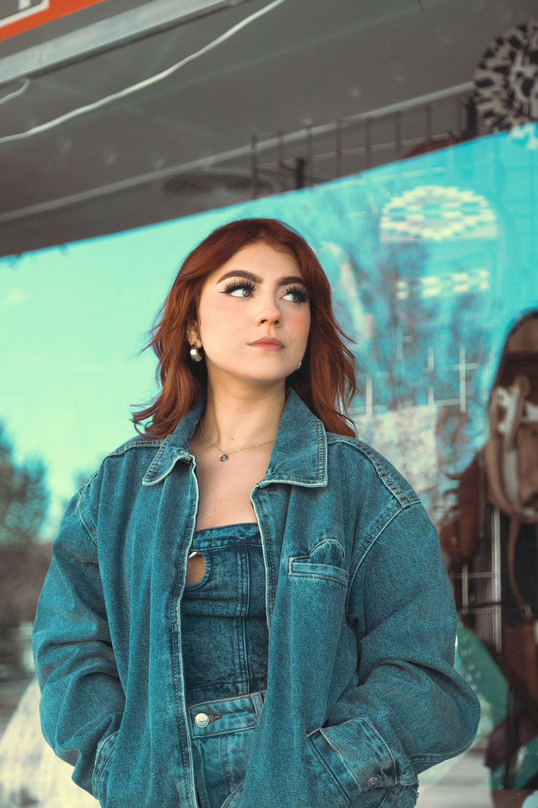 a woman standing in front of a painting