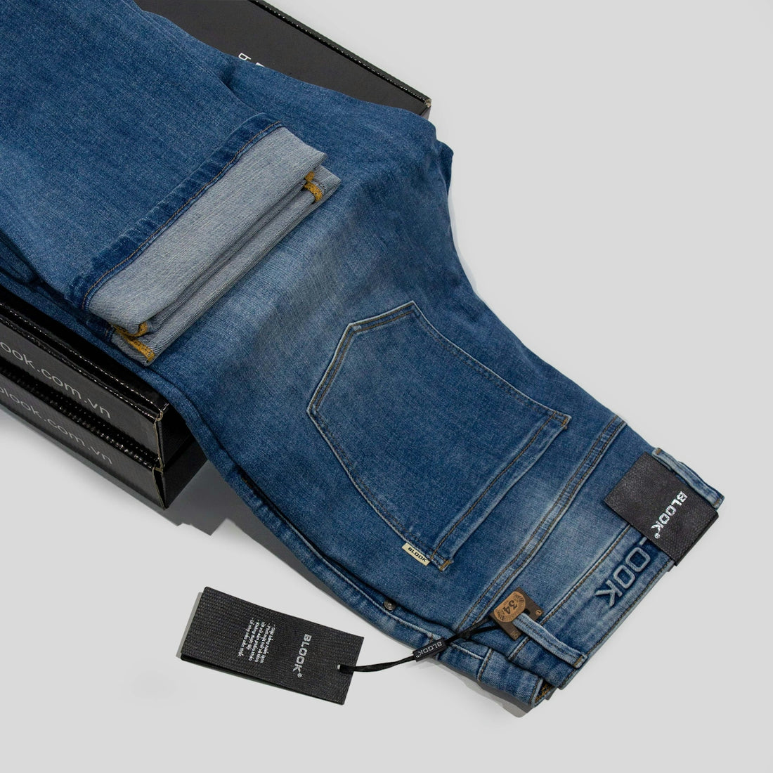a pair of blue jeans sitting on top of a box