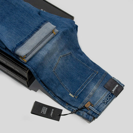 a pair of blue jeans sitting on top of a box