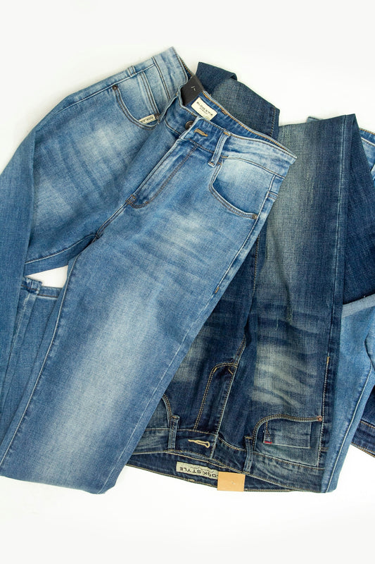 A pile of jeans laying on top of each other