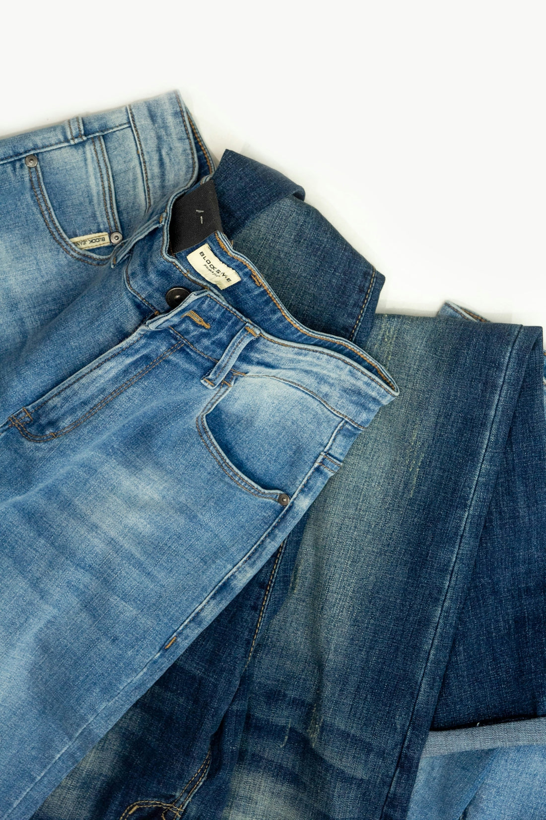 A pair of jeans laying on top of each other