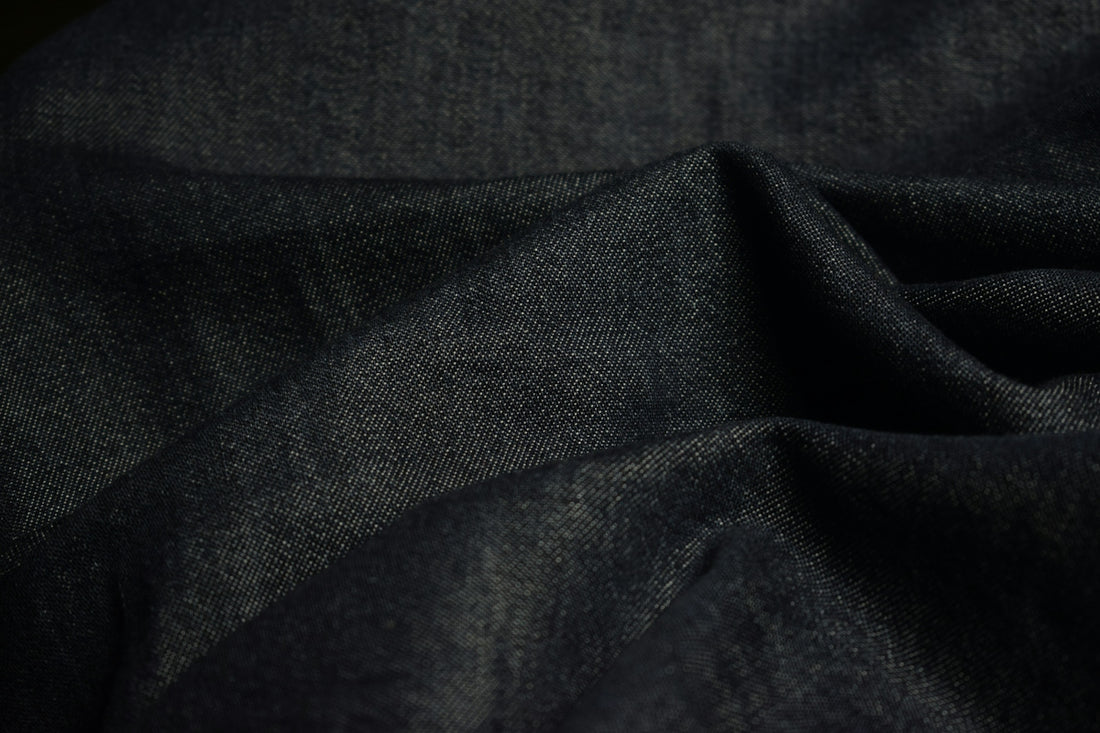 Dark blue textured fabric with soft folds