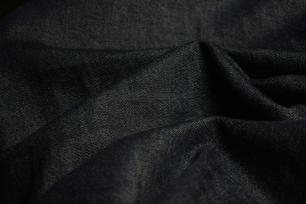 Dark blue textured fabric with soft folds