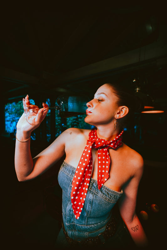 Woman in denim top with red polka dot scarf