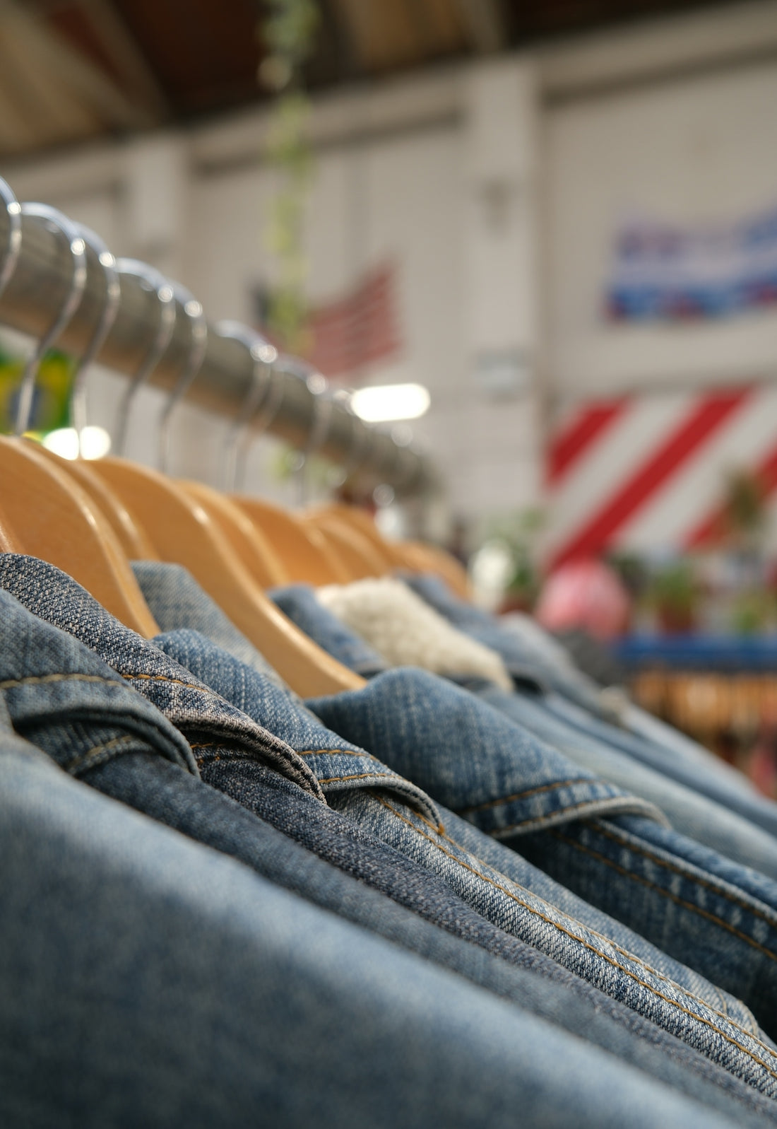 Denim jackets hanging on a rack in a store
