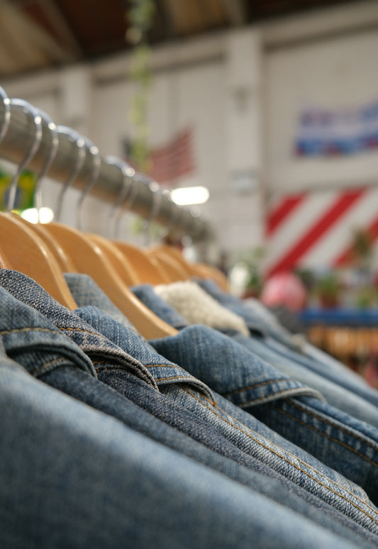 Denim jackets hanging on a rack in a store