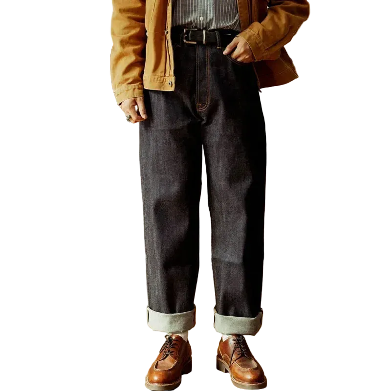 Men's dark wash denim pants with a relaxed fit, rolled cuffs, and contrasting stitching, perfect for casual style.